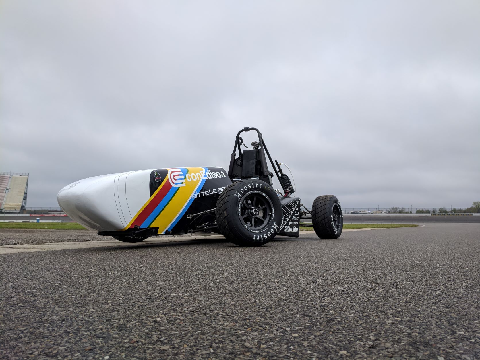 Final shot of the 2018 car. There are no wings on it. The main focus is the front left wheel which is turned to the right.