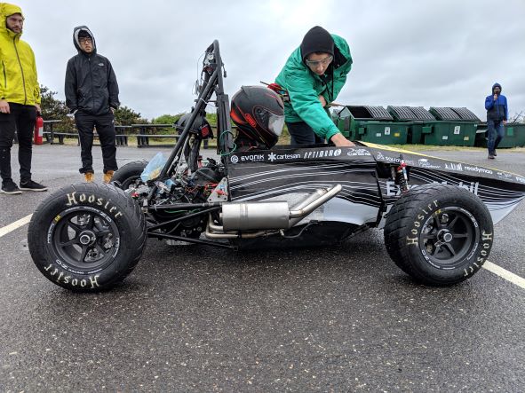 The 2019 car at a test day. It is in the rain, the ground is wet. The engine is screaming. Life is good.