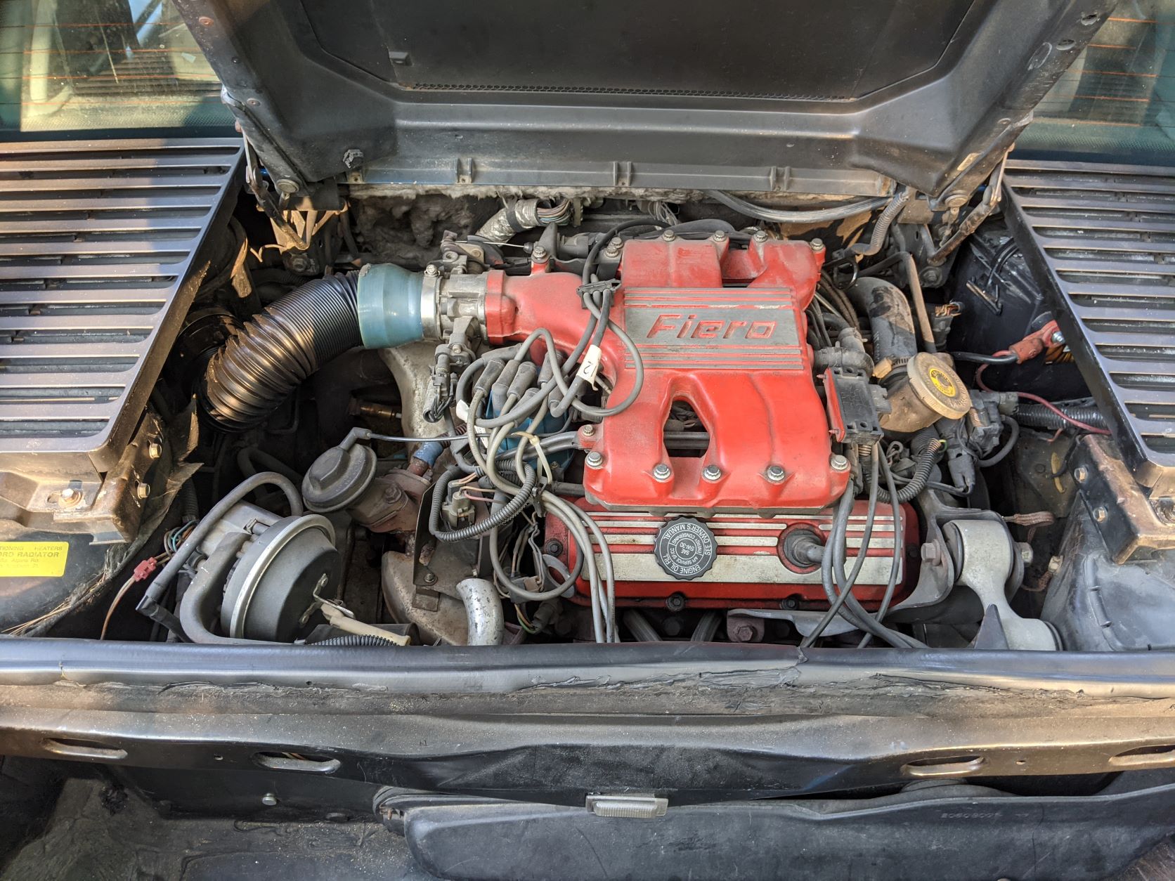 Image of the original engine bay. Note the home depot tubing being used in place of the intake